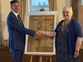 Past president Brett Dennis 'hands over' to incoming president Maria Woodward